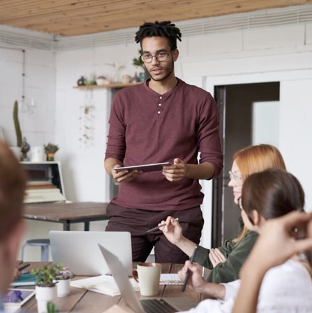 a photo is shown that represents a meeting/brainstorming between a group of people within the company