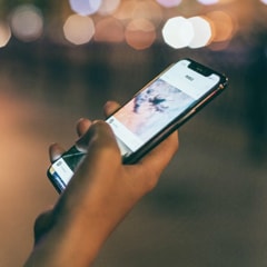 there is a photo of a user holding a smartphone