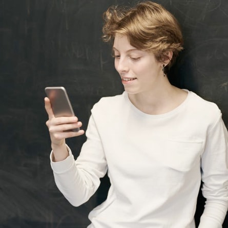 there is a photo of a girl holding a smartphone